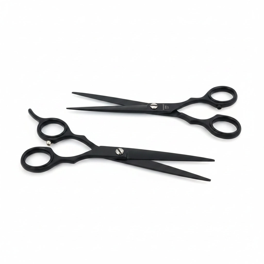 Two black hairdressing scissors on a white background