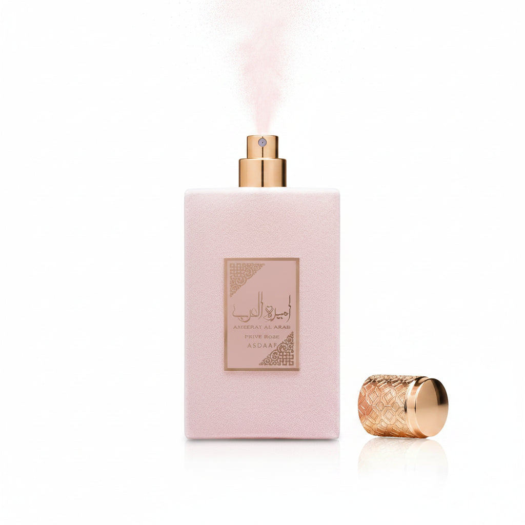 Perfume bottle with pink packaging and gold cap on a white background