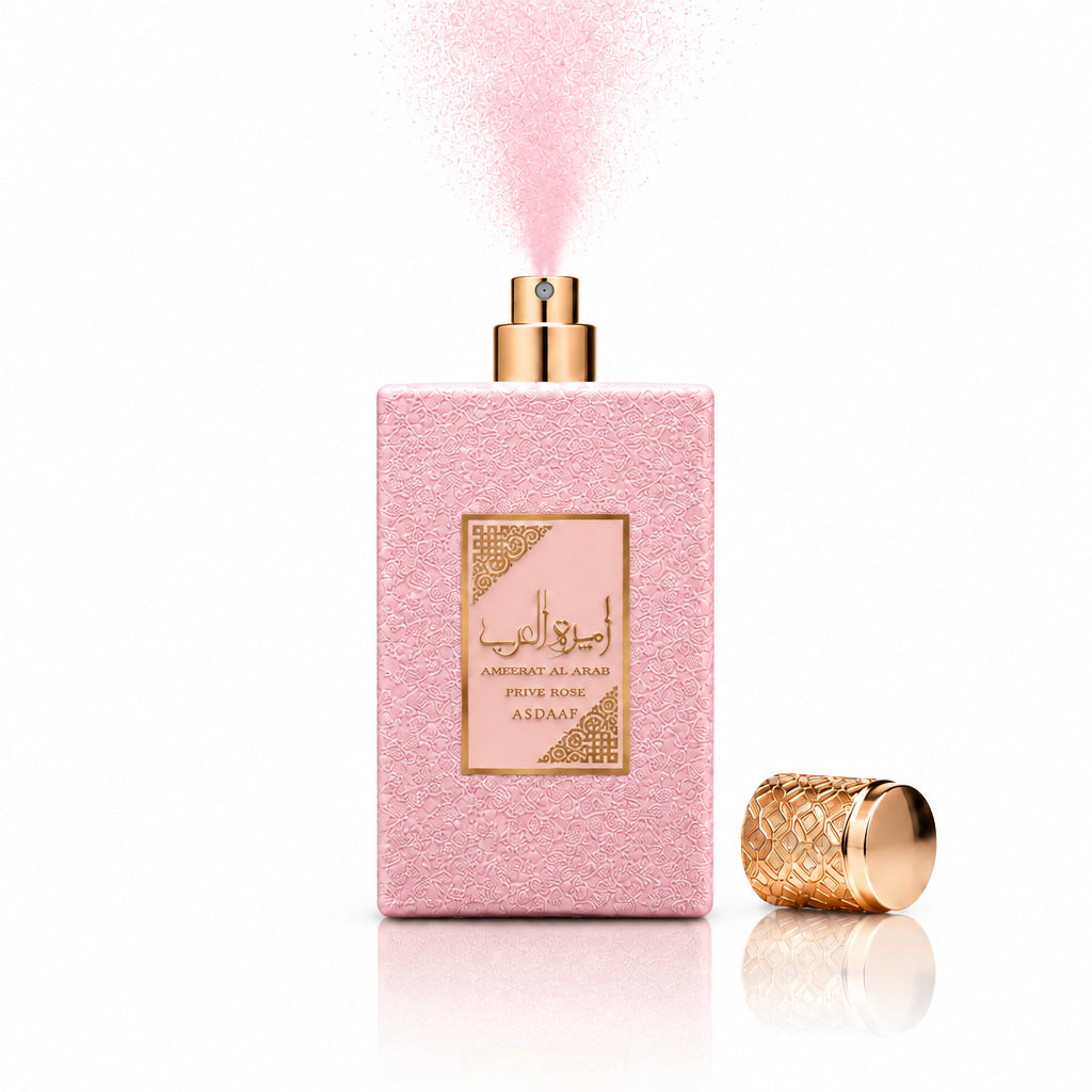 Perfume bottle with pink packaging and gold cap on a white background