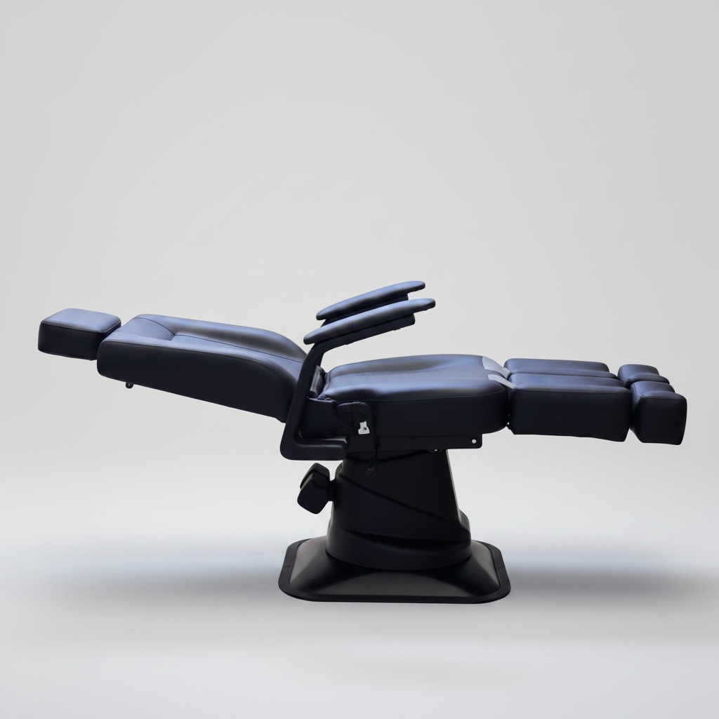 Black leather reclining massage or treatment chair with adjustable headrest, armrests, and extended footrest, shown on a plain white background.