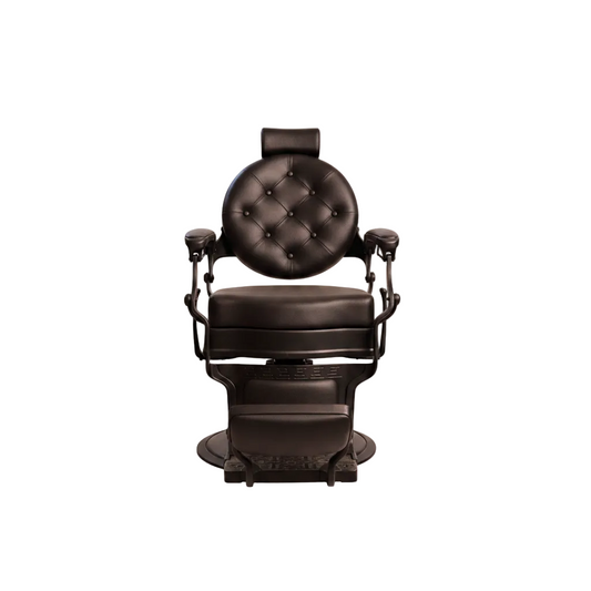 A dark brown barbershop barber chair with a tufted backrest, padded seat, armrests, and an attached footrest, shown on a plain white background.