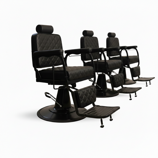 A black barber chair with quilted upholstery, a circular base, armrests, and an attached footrest, shown on a plain white background.