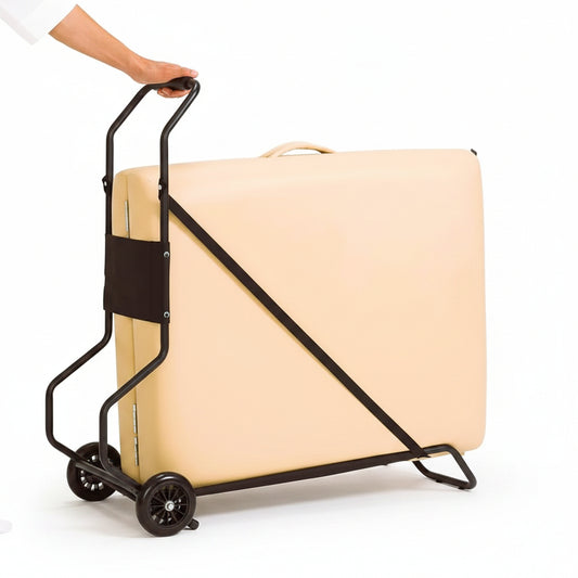 A beige rectangular mattress or padded panel secured on a black metal rolling dolly with wheels, shown against a plain white background. A person's arm and hand are visible holding the handle.